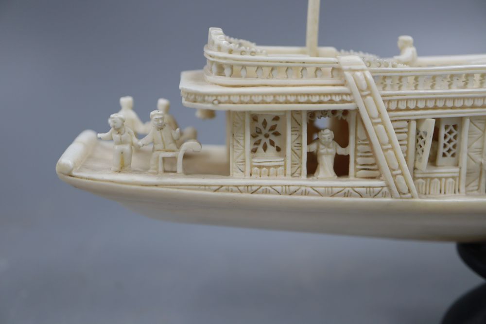 A Chinese carved ivory boat, on stand, length 23cm